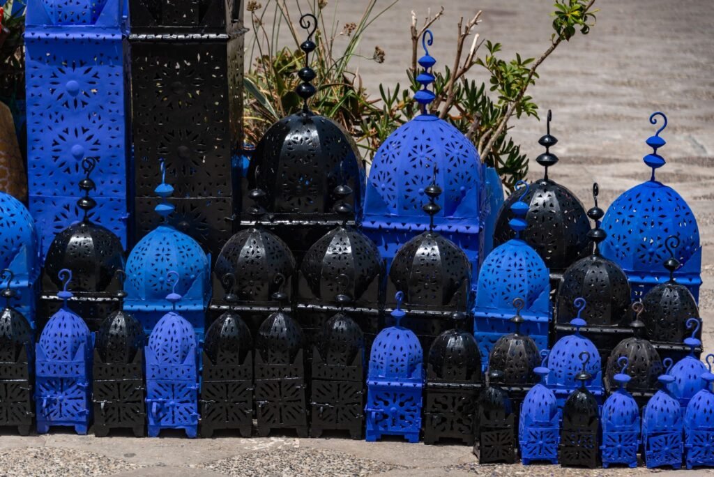 Vibrant blue and black Moroccan lanterns in an outdoor setting, perfect for decoration.
